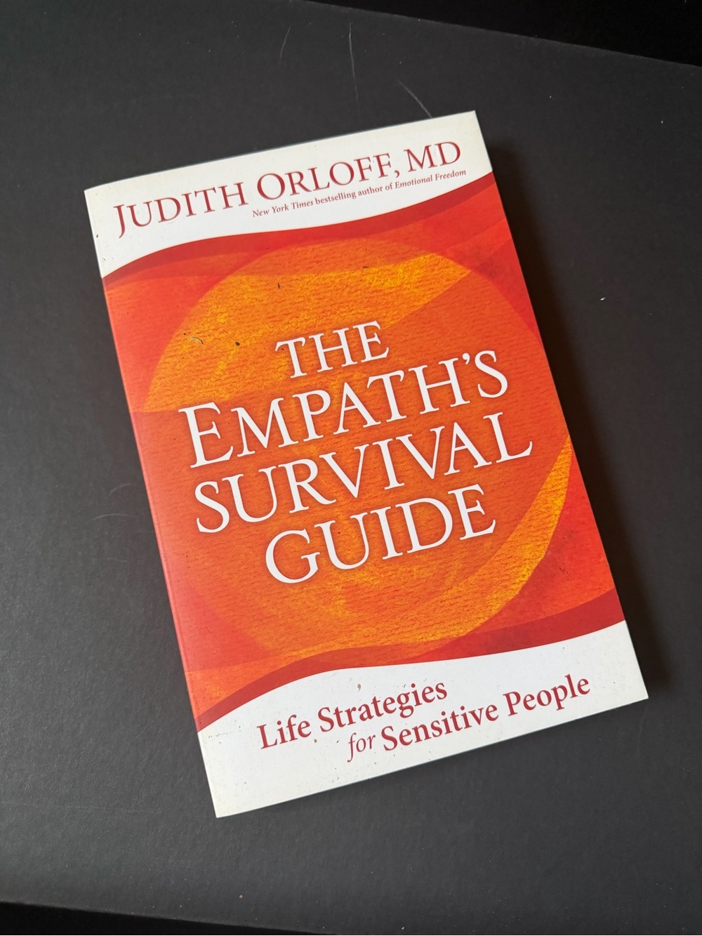 The Empath's Survival Guide by Judith Orloff - Orange & White Paperback Book